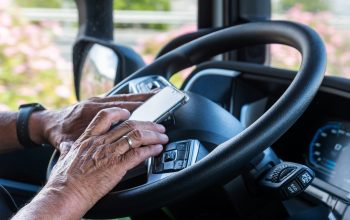 The,Hands,Of,A,Senior,Truck,Driver,Texting,On,His The,Hands,Of,A,Senior,Truck,Driver,Texting,On,His